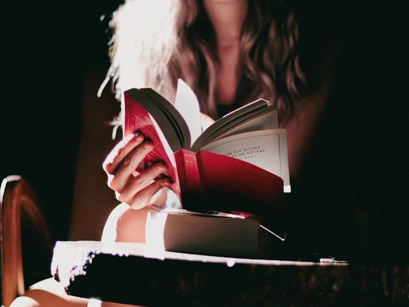 A calm and focused person sitting in a well-lit room.